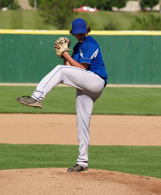 A baseball pitcher throws from the mound.