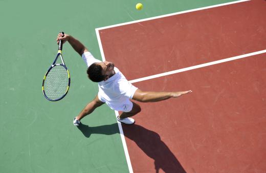 Tennis umpires are positioned around the outside of the court.