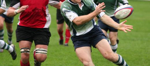 In rugby, the goal is to advance the ball past the opposing team's goal line by passing to each other.