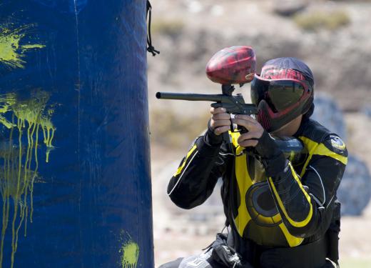 Balls of paint are shot at people during the game of paintball.