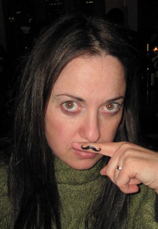 A woman showing a fingerstache.