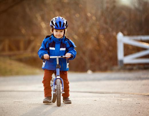 Riding with training wheels can help children learn how to balance on a bike.