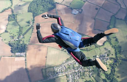 A parachute is carefully folded and packed on a skydiver's back.